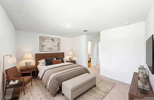 a bedroom with a bed and a chair