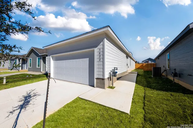 a front view of house with yard and garage