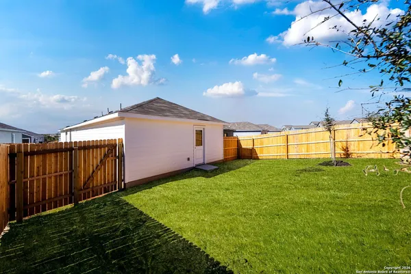 a view of a backyard of the house