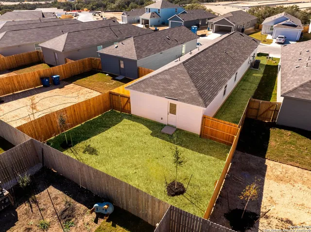 an aerial view of residential houses with outdoor space