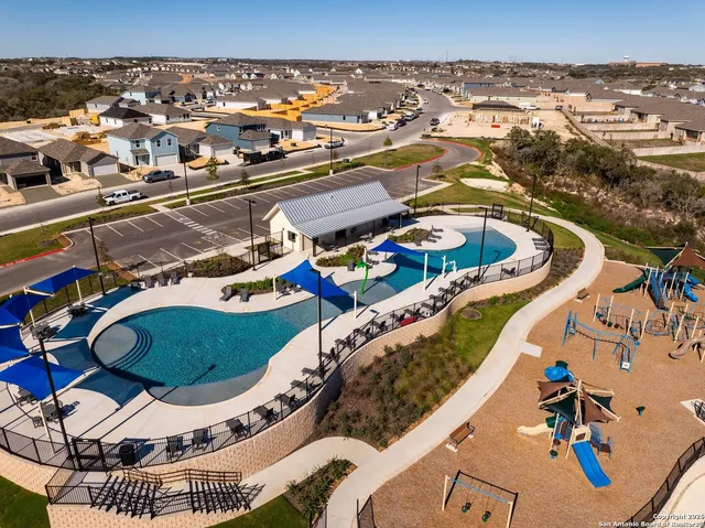 a view of a swimming pool with outdoor seating