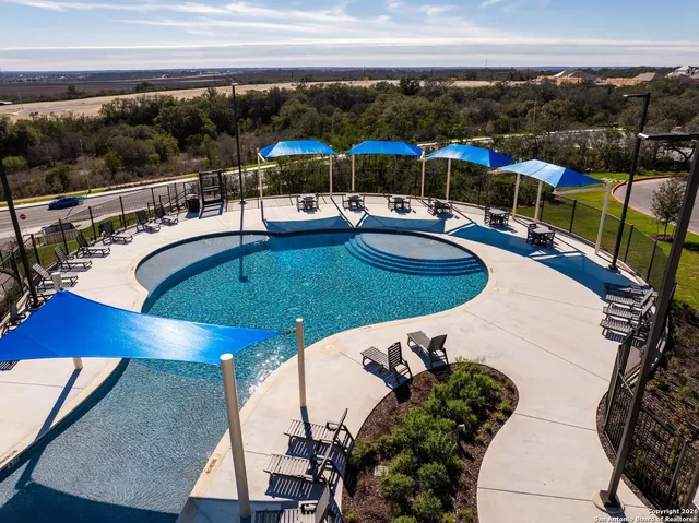 a view of a swimming pool with seating area