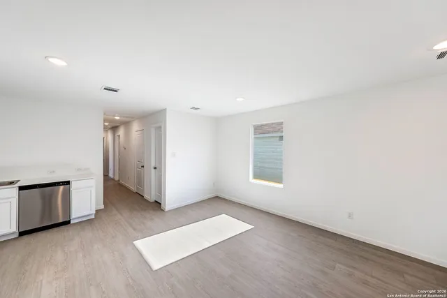 an empty room with windows and closet