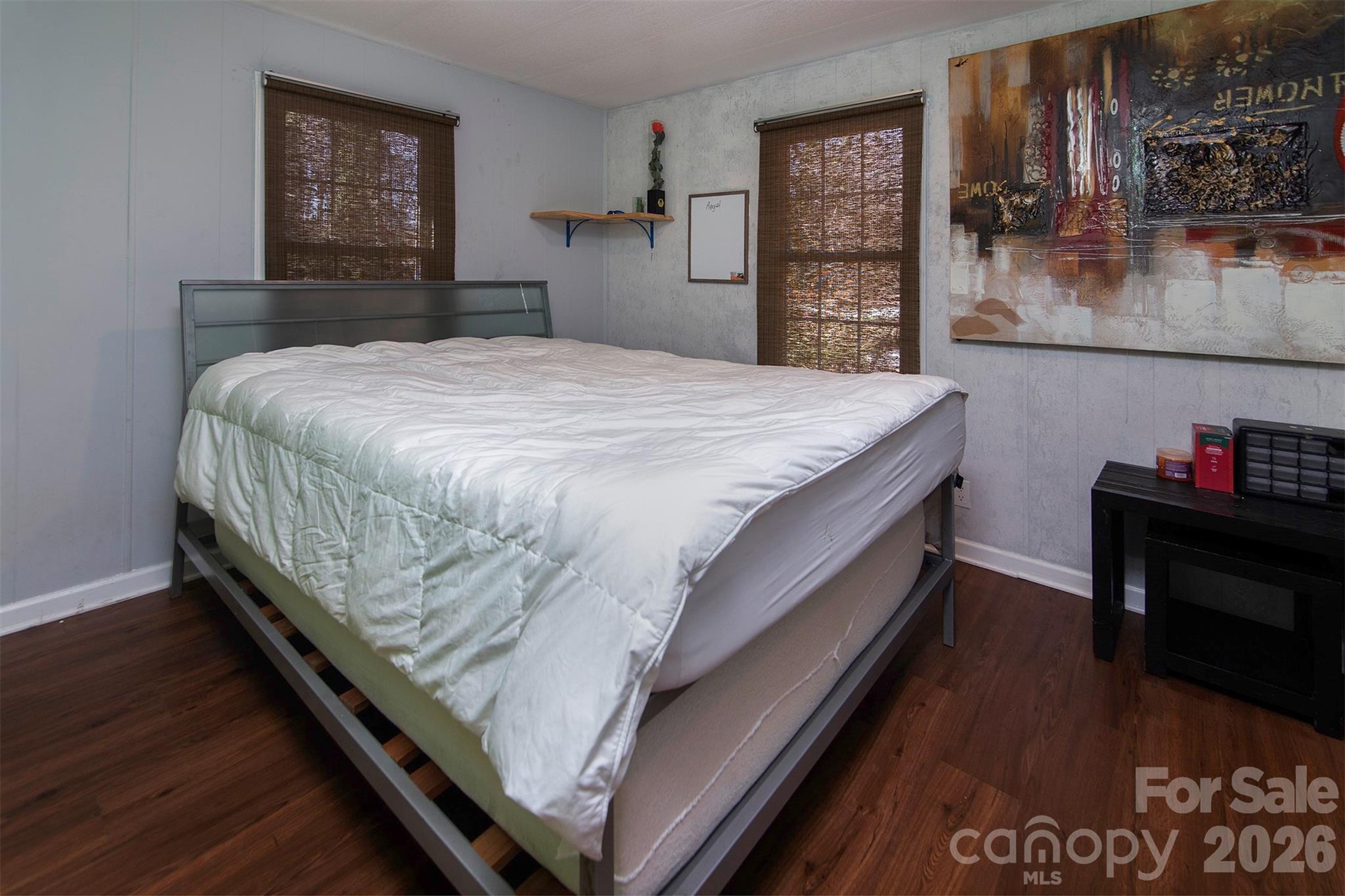 5727 Thompson Road Charlotte, NC 28216 - Photo 14 of 21 a bed sitting in a bedroom next to a window