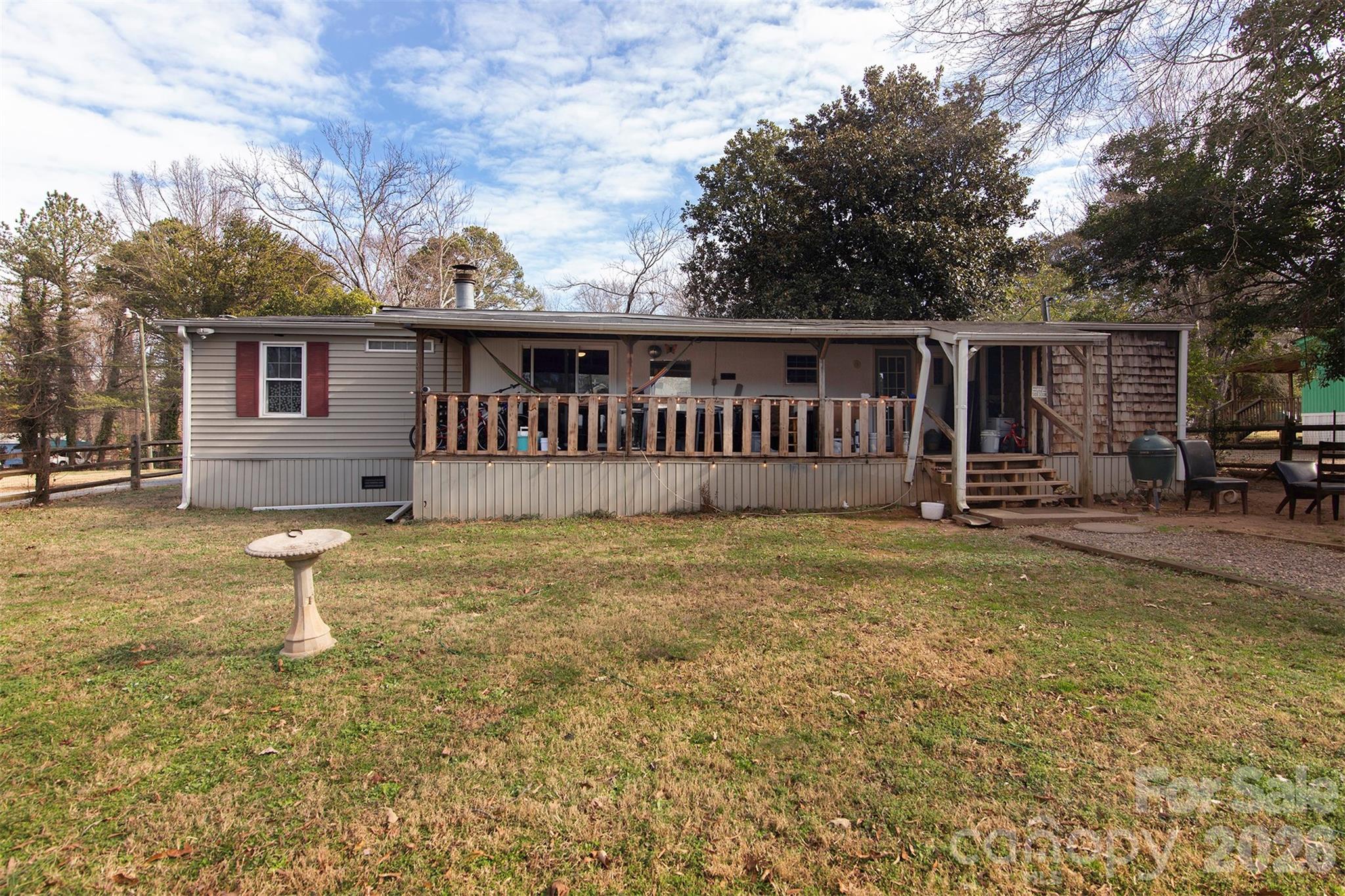 5727 Thompson Road Charlotte, NC 28216 - Photo 2 of 21 a view of a house with backyard and sitting area