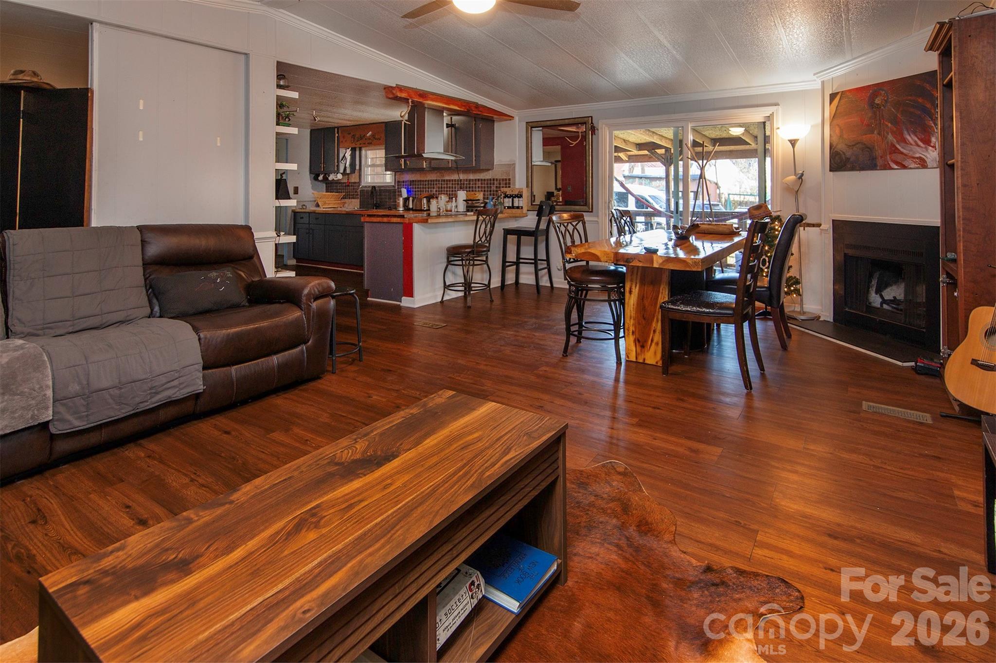 5727 Thompson Road Charlotte, NC 28216 - Photo 5 of 21 a living room with furniture a fireplace and a dining table with kitchen view
