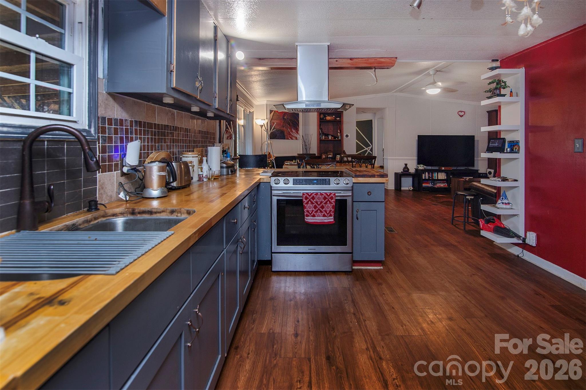 5727 Thompson Road Charlotte, NC 28216 - Photo 7 of 21 a kitchen with stainless steel appliances granite countertop a stove and a wooden floors