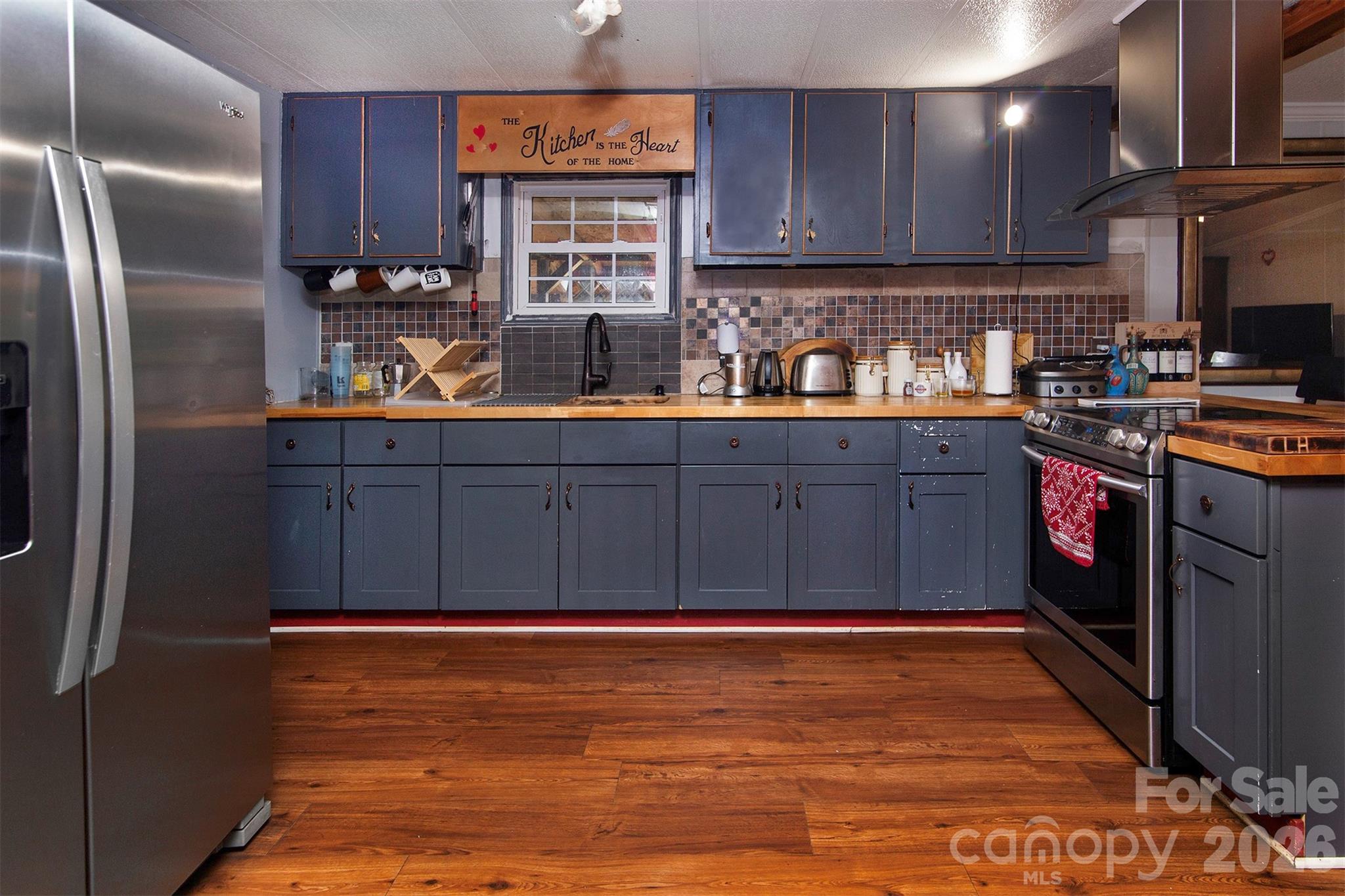 5727 Thompson Road Charlotte, NC 28216 - Photo 8 of 21 a kitchen with stainless steel appliances granite countertop a refrigerator and a stove top oven