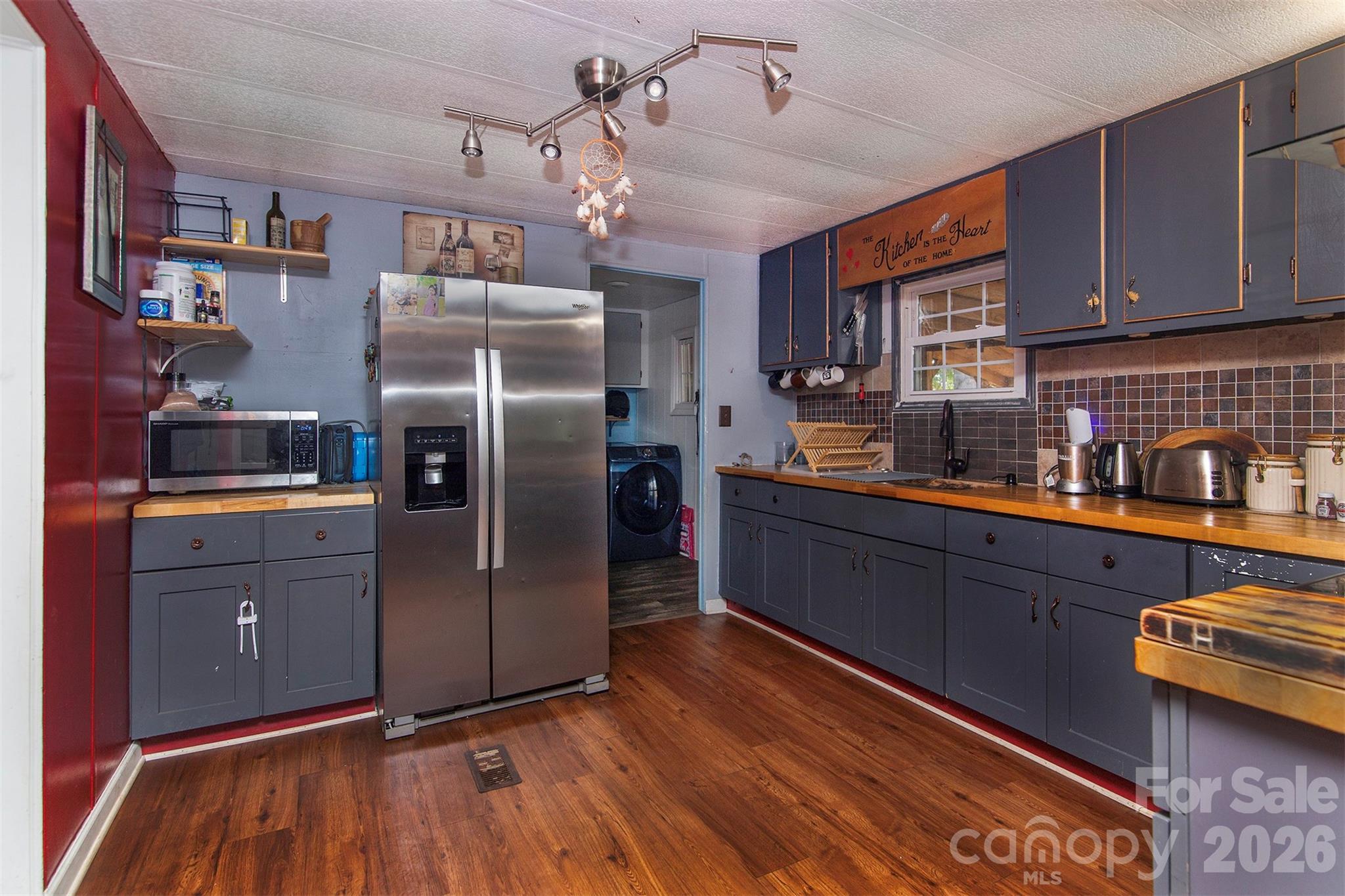 5727 Thompson Road Charlotte, NC 28216 - Photo 9 of 21 a kitchen with stainless steel appliances granite countertop a refrigerator and a sink