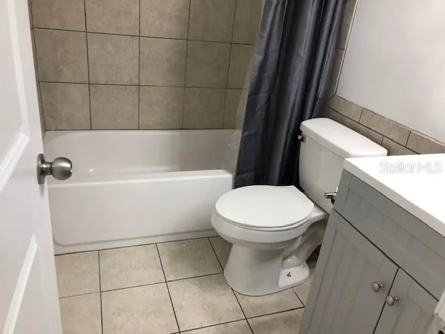 a white toilet sitting next to a bath tub