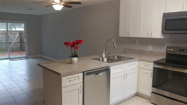 a kitchen with a sink cabinets and stainless steel appliances