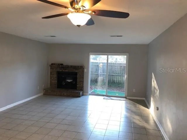 a view of a livingroom with a ceiling fan and window