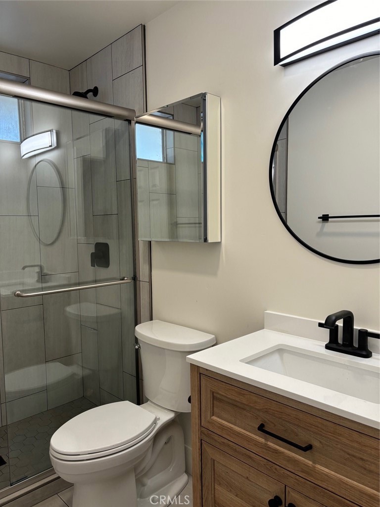 921 Regal Road Encinitas, CA 92024 - Photo 11 of 23 a bathroom with a sink toilet and shower