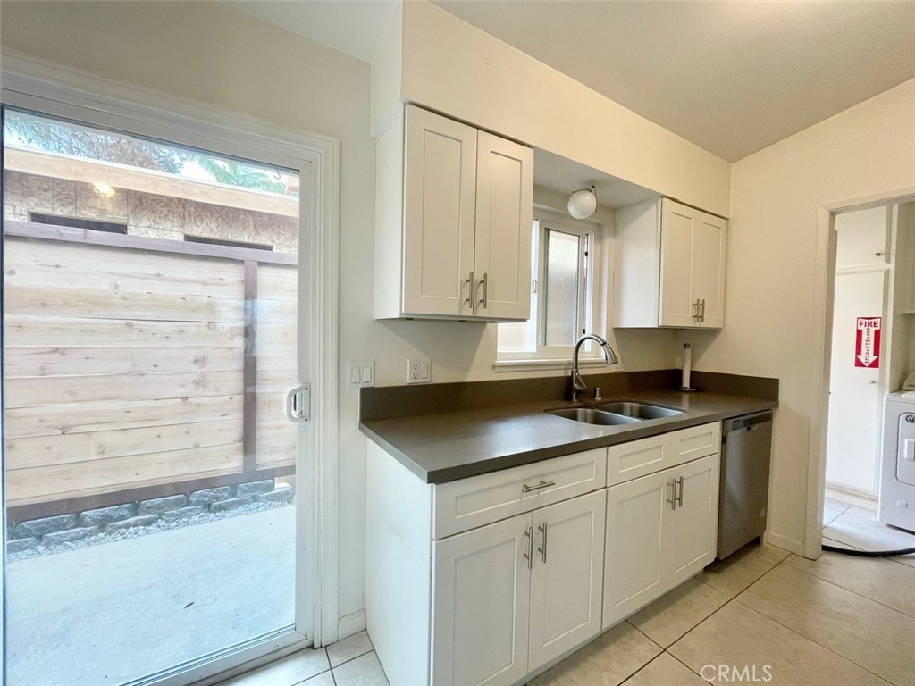 921 Regal Road Encinitas, CA 92024 - Photo 13 of 23 a kitchen with granite countertop stainless steel appliances white cabinets and a sink