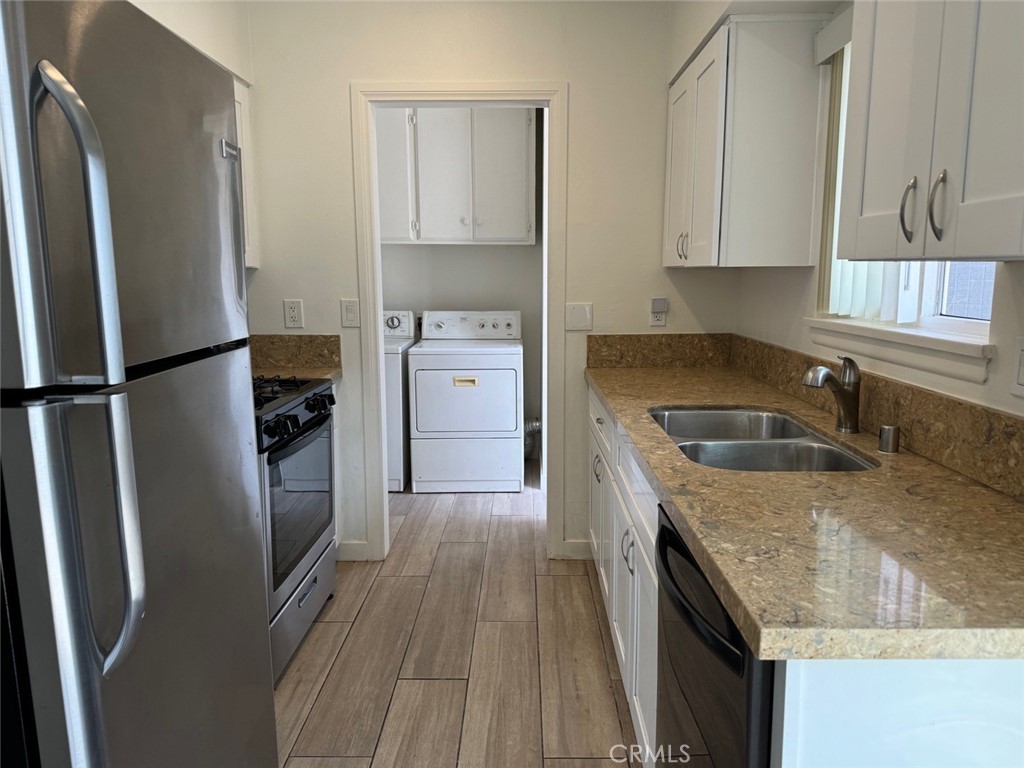 921 Regal Road Encinitas, CA 92024 - Photo 18 of 23 a kitchen with a refrigerator sink and stove