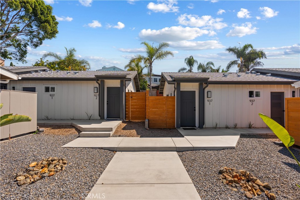 921 Regal Road Encinitas, CA 92024 - Photo 2 of 23 a front view of a house with a yard and garage