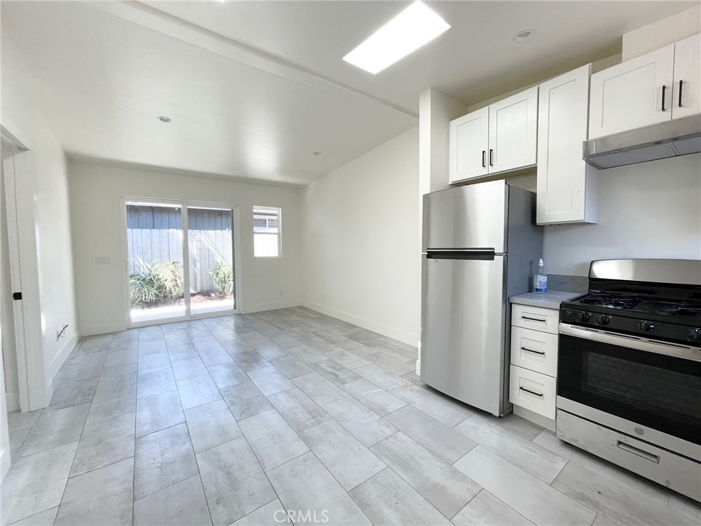 921 Regal Road Encinitas, CA 92024 - Photo 3 of 23 a view of a kitchen with refrigerator and microwave