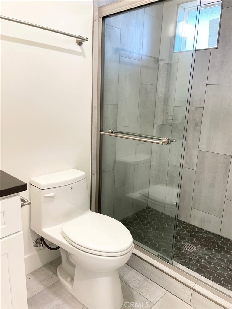 921 Regal Road Encinitas, CA 92024 - Photo 7 of 23 a bathroom with a toilet and a shower