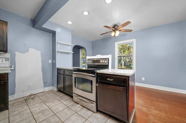 a kitchen with stainless steel appliances granite countertop a stove a sink and a refrigerator