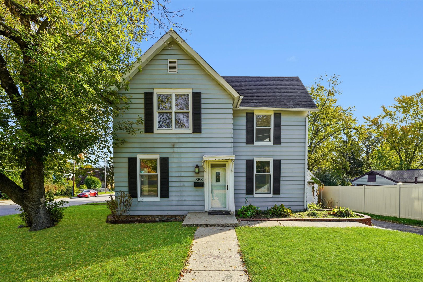353 Wilcox Avenue Elgin, IL 60123 - Photo 2 of 19 a front view of a house with a yard and trees