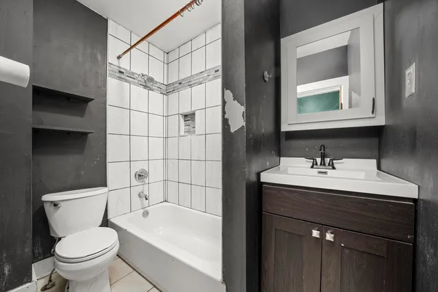a bathroom with a sink toilet vanity and shower