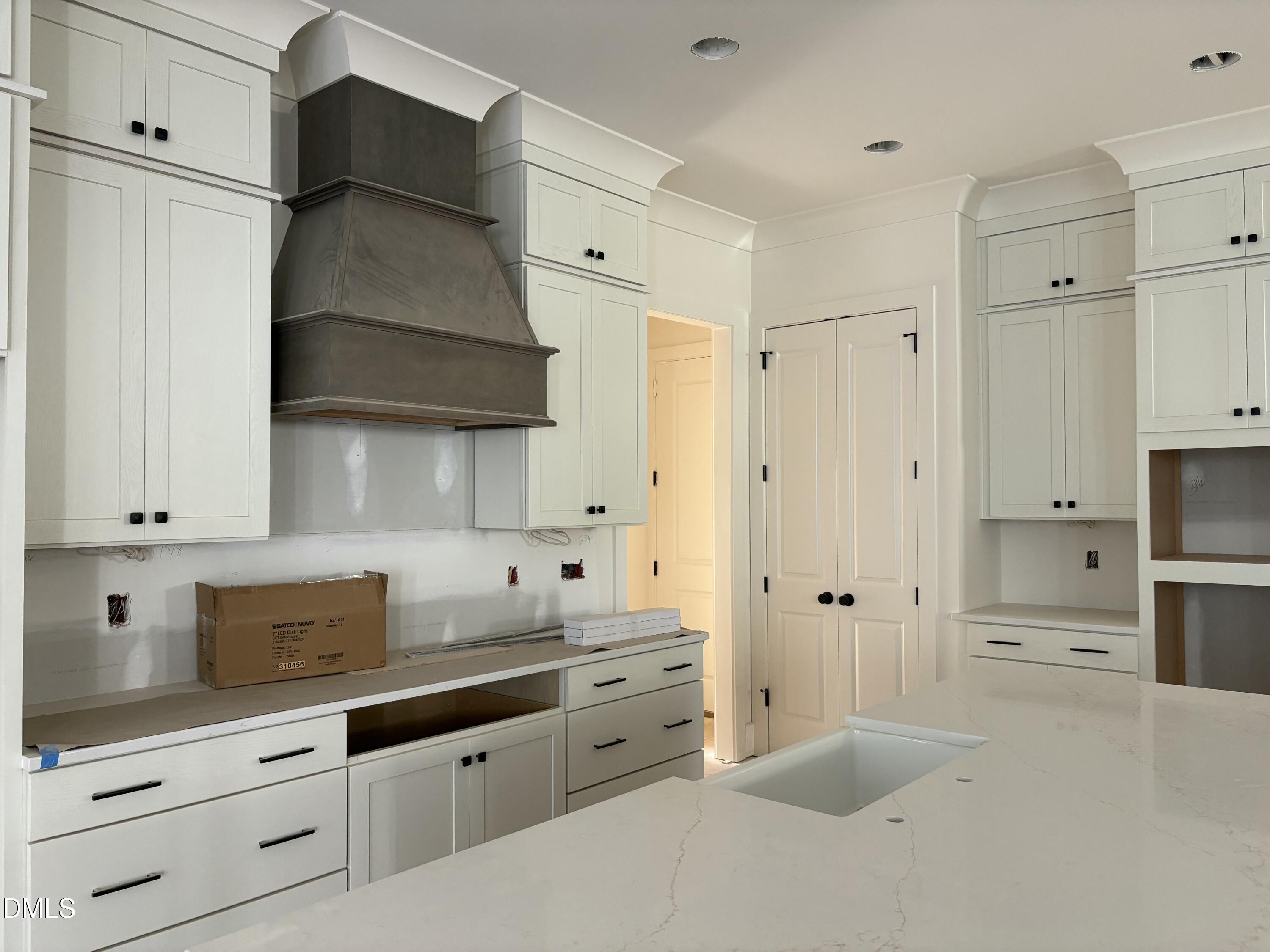 829 Chapel Ridge Drive Pittsboro, NC 27312 - Photo 4 of 23 a kitchen with white cabinets and stainless steel appliances