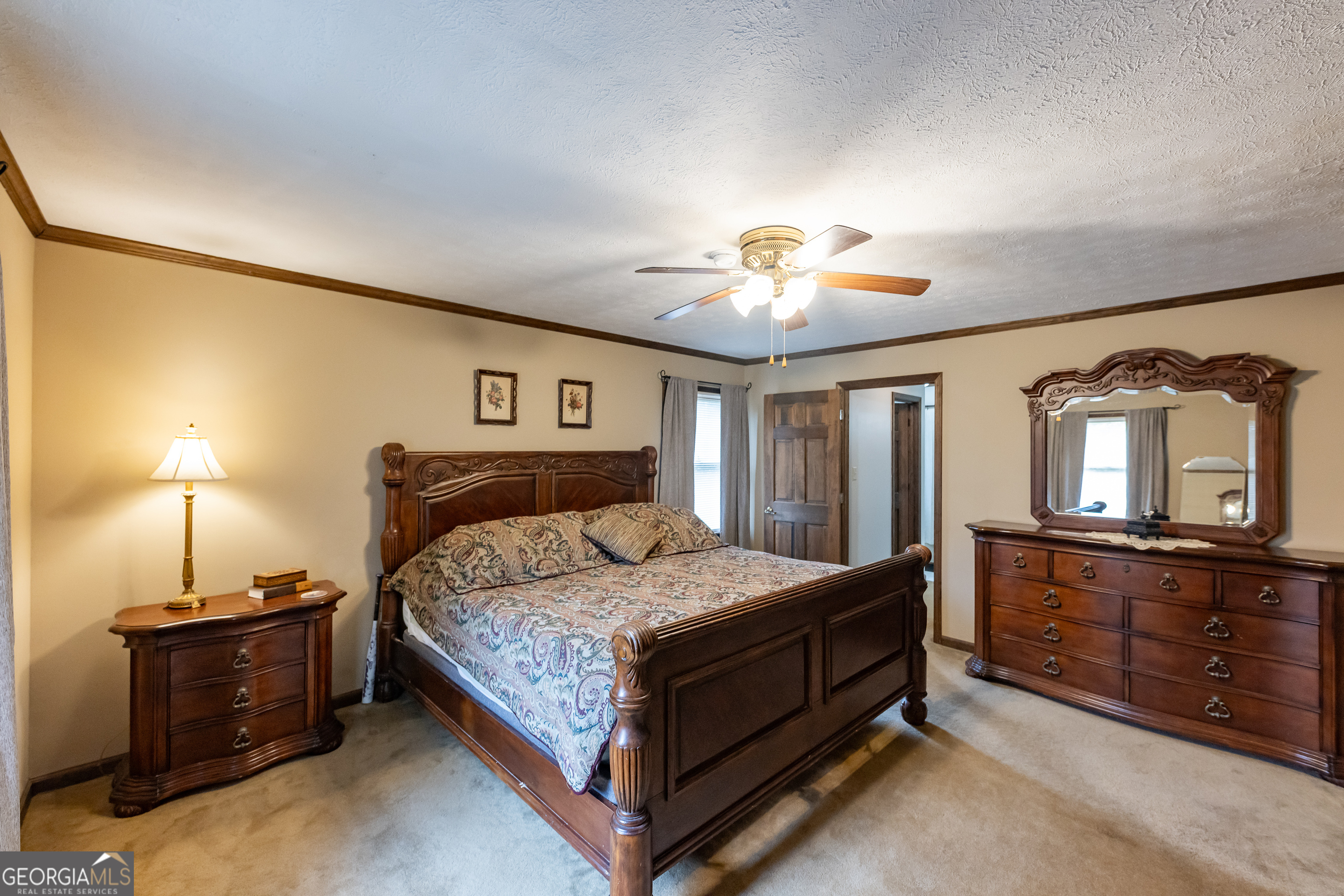 976 Windsweep Farm Road Thomaston, GA 30286 - Photo 14 of 98 a bedroom with a bed and lamp on dresser