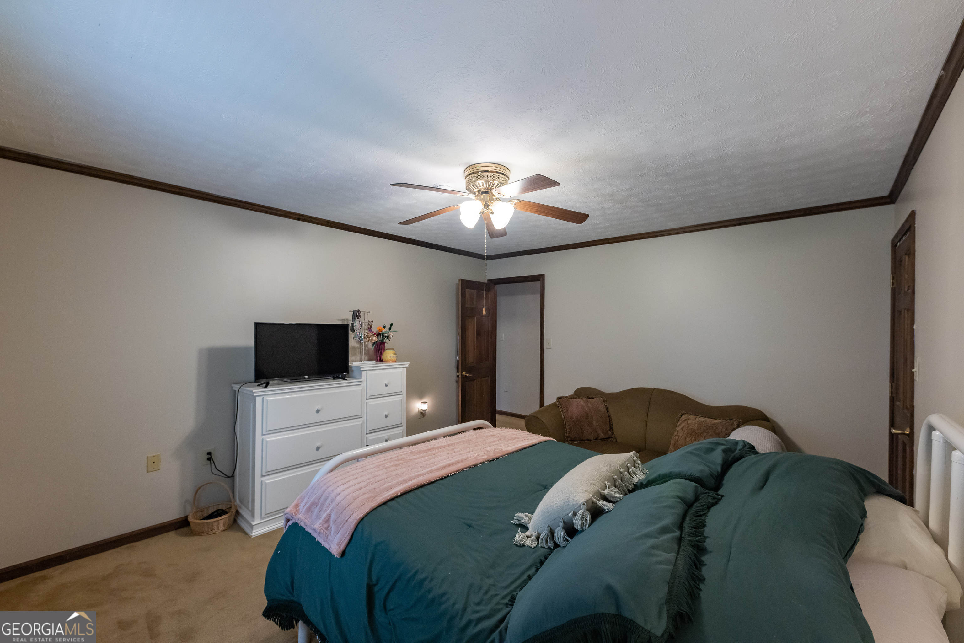 976 Windsweep Farm Road Thomaston, GA 30286 - Photo 20 of 98 a bedroom with a bed and a chandelier