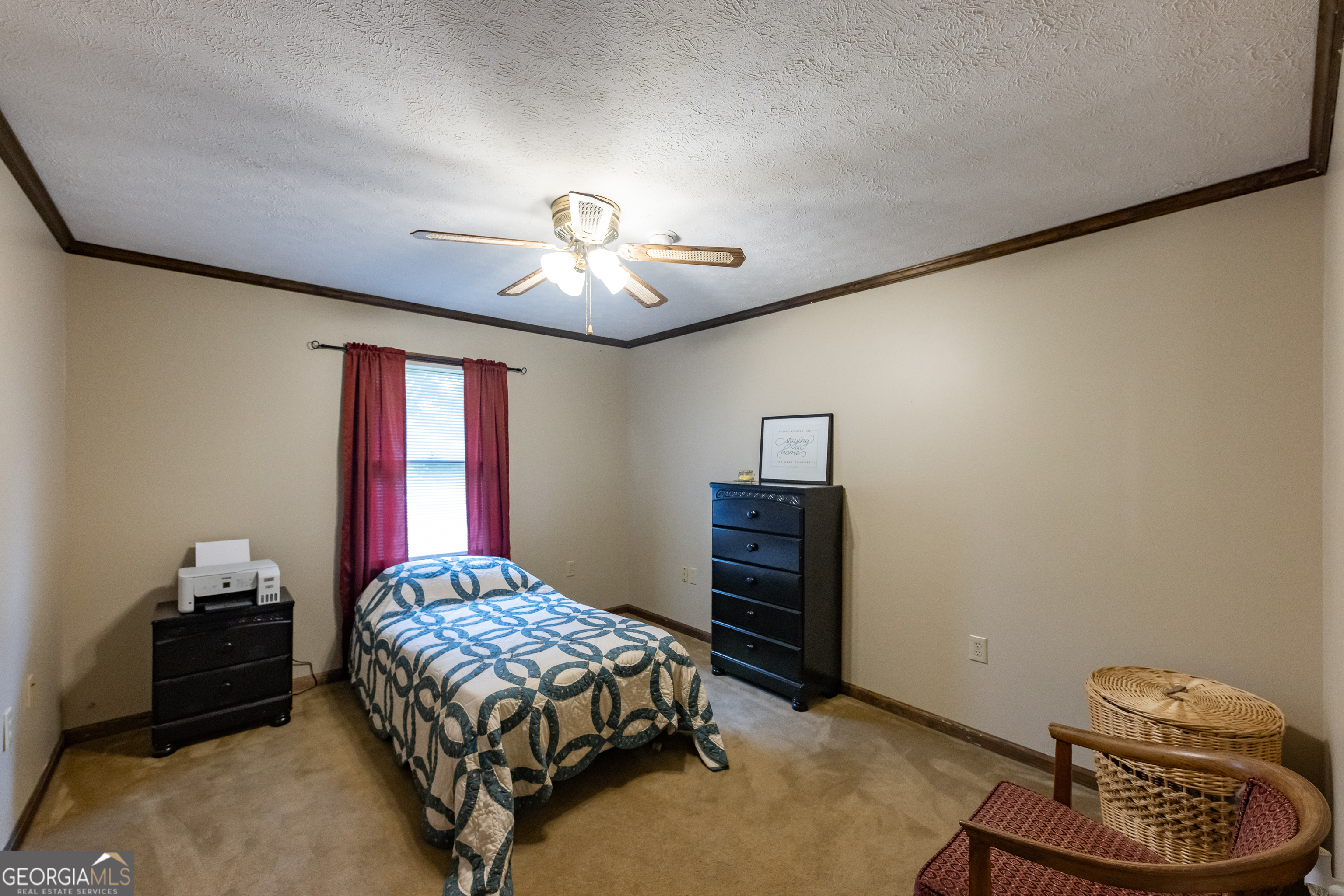 976 Windsweep Farm Road Thomaston, GA 30286 - Photo 23 of 98 a bedroom with a bed and a chandelier