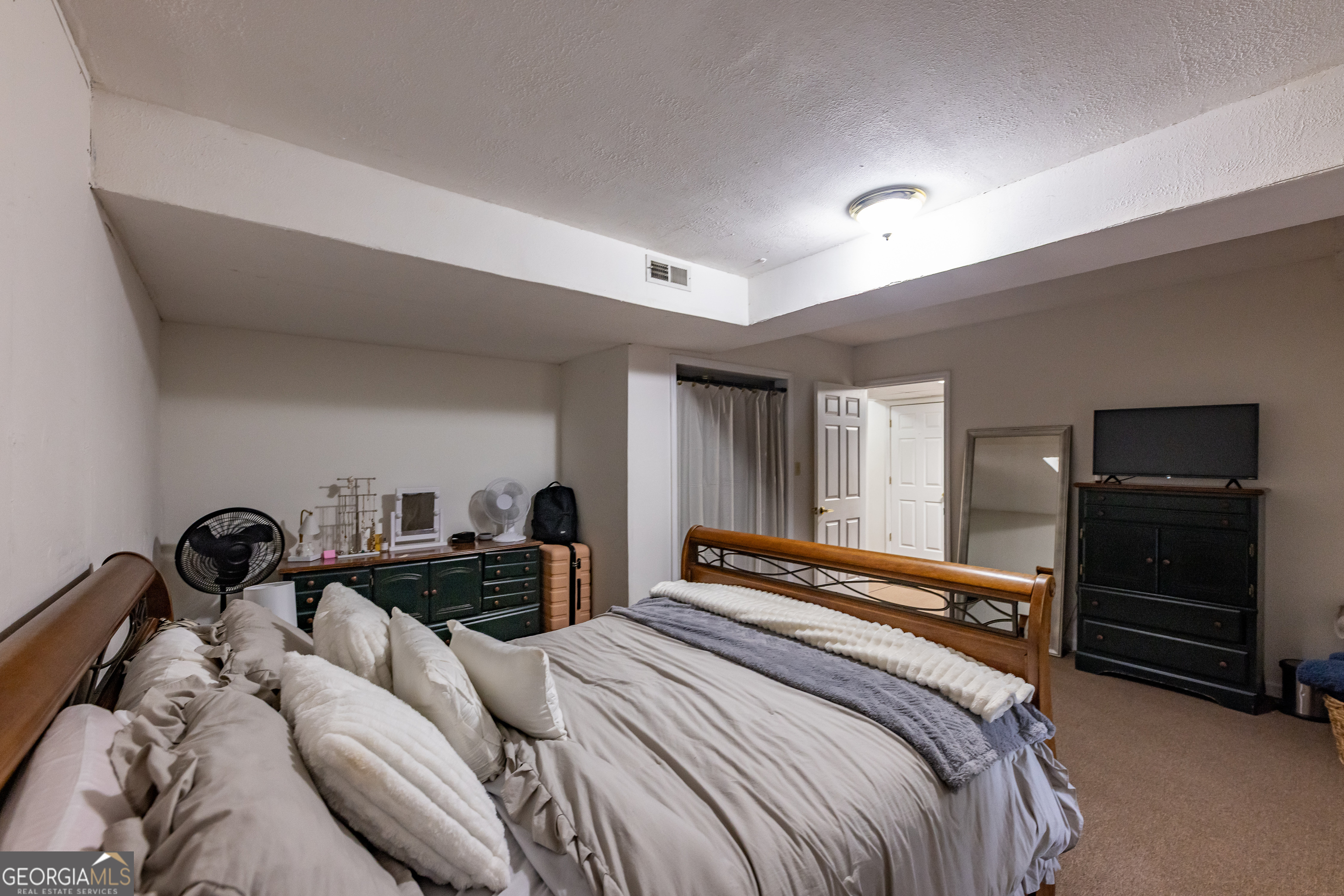 976 Windsweep Farm Road Thomaston, GA 30286 - Photo 31 of 98 a bedroom with a bed and a walk in closet