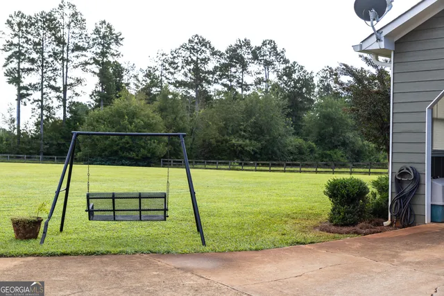 an aerial view of a house with a yard basket ball court and outdoor seating
