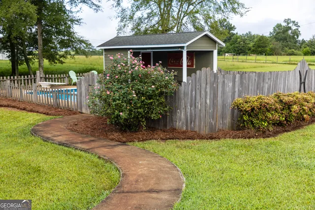 an aerial view of a house with a yard and trees