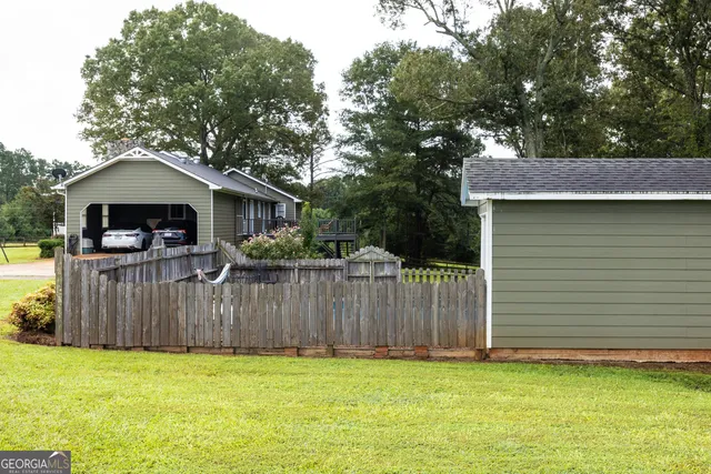 a view of a house with a yard patio and fire pit