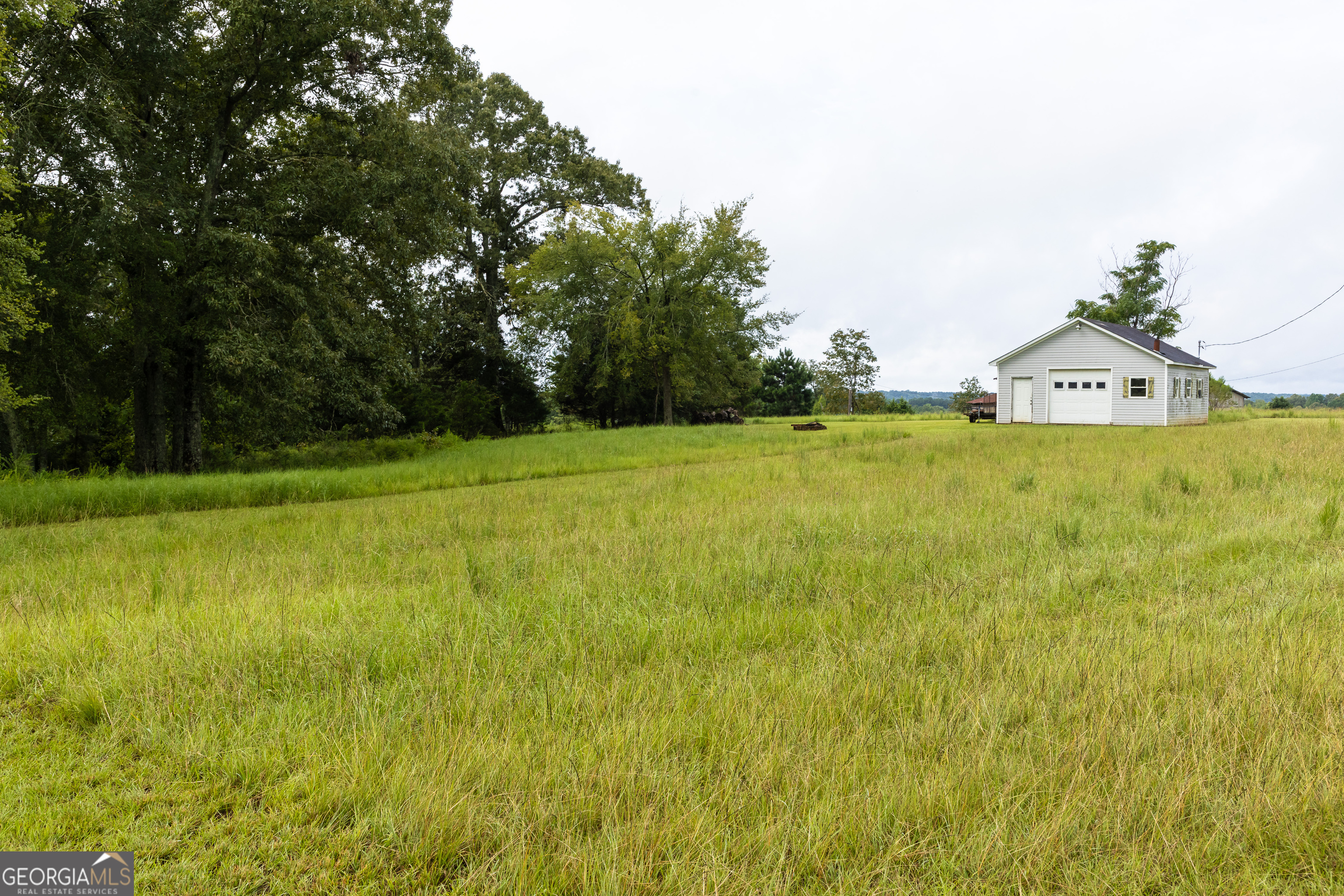 976 Windsweep Farm Road Thomaston, GA 30286 - Photo 52 of 98 a view of a field with an trees in the background