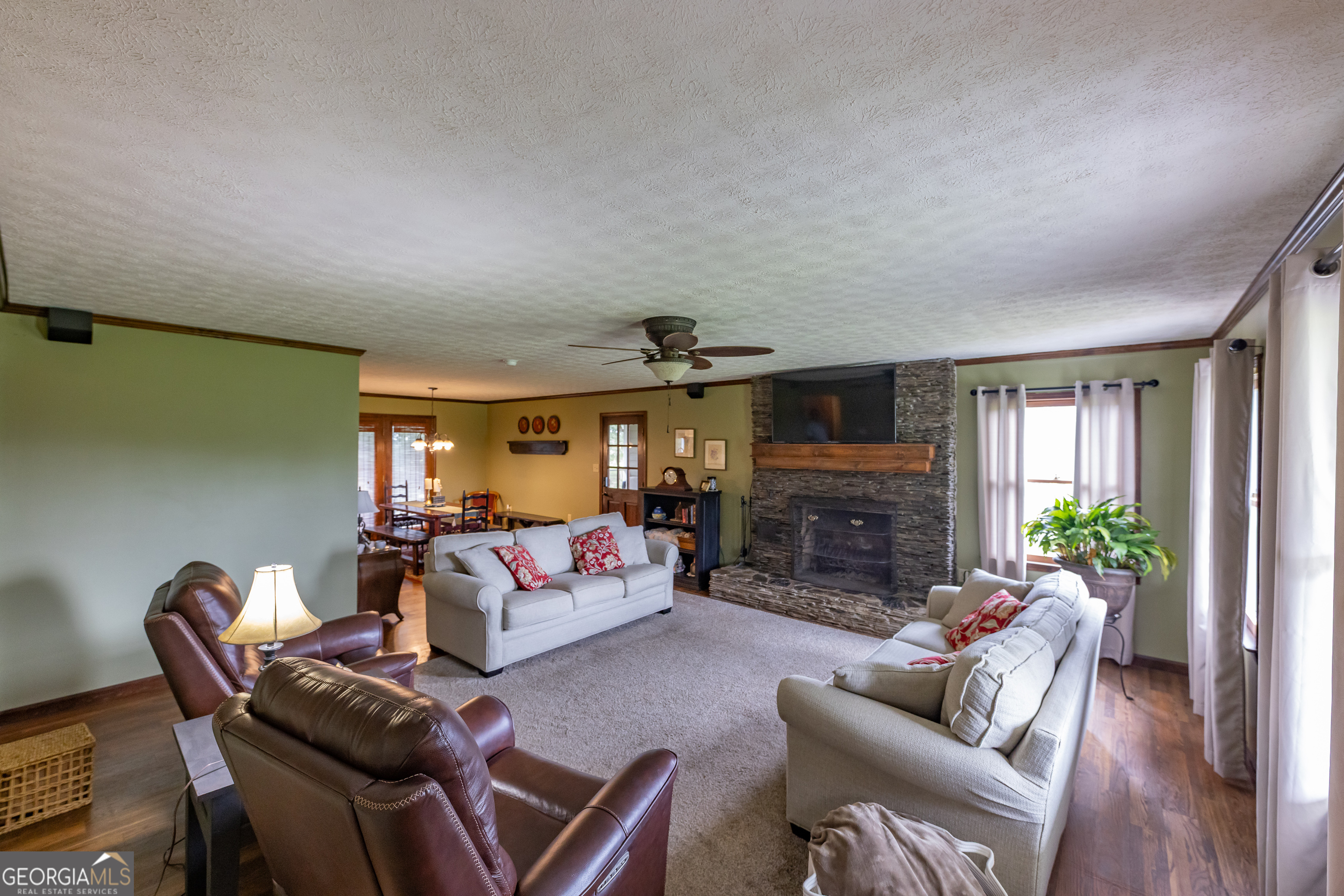 976 Windsweep Farm Road Thomaston, GA 30286 - Photo 7 of 98 a living room with fireplace furniture and a flat screen tv
