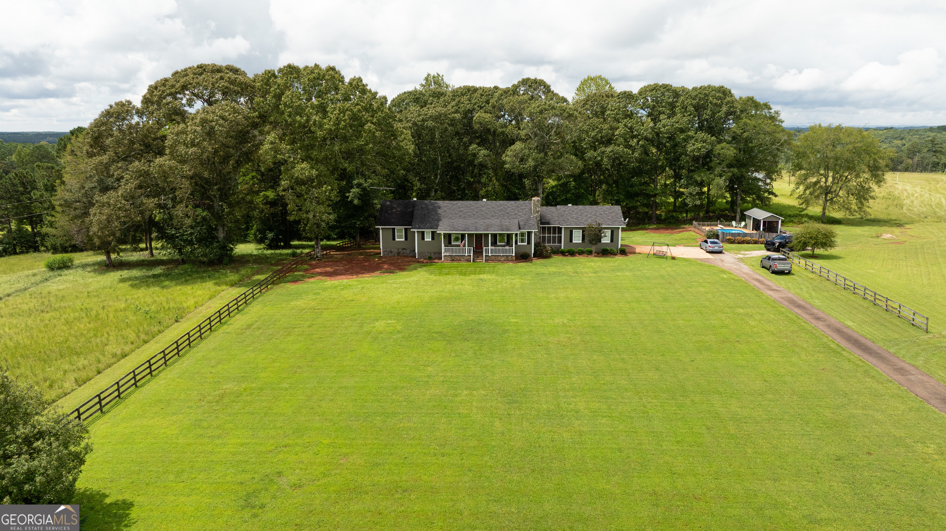 976 Windsweep Farm Road Thomaston, GA 30286 - Photo 71 of 98 a view of a swimming pool with an outdoor seating and a garden