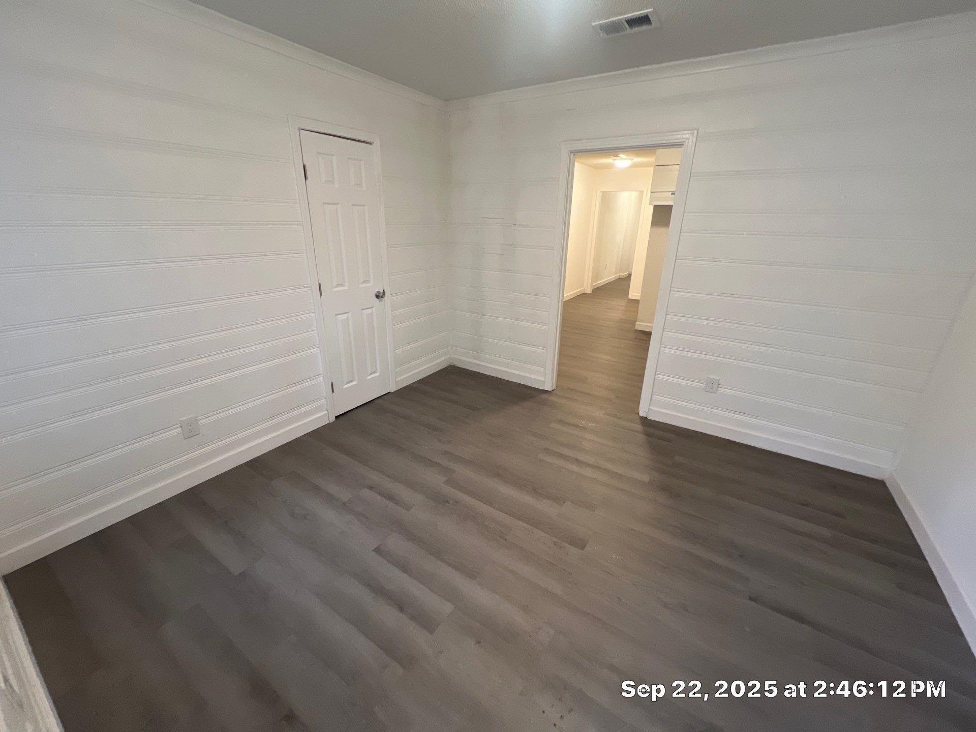 2773 Waverly Avenue Memphis, TN 38114 - Photo 11 of 20 a view of an empty room with wooden floor and a window