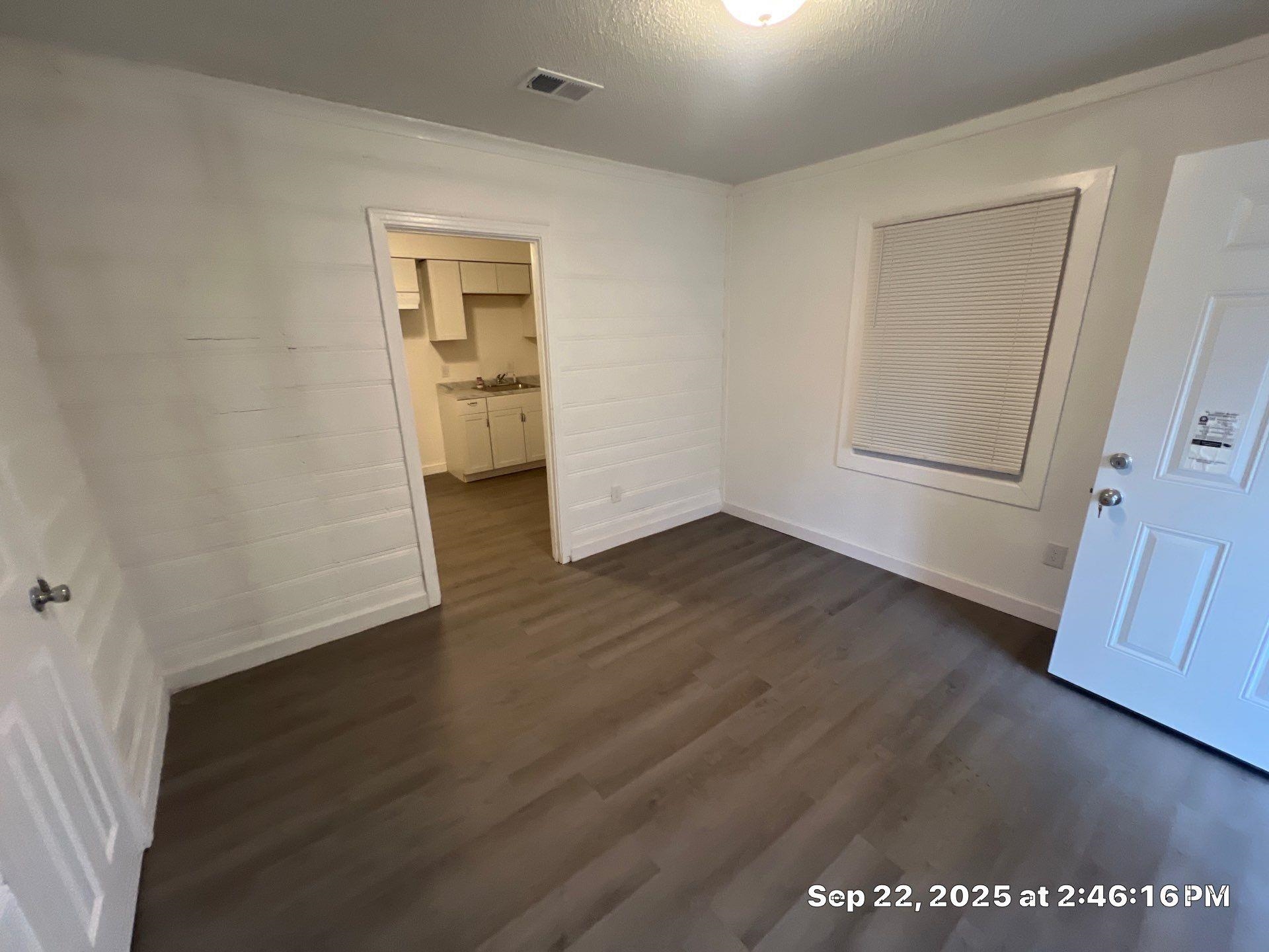 2773 Waverly Avenue Memphis, TN 38114 - Photo 12 of 20 an empty room with wooden floor and door