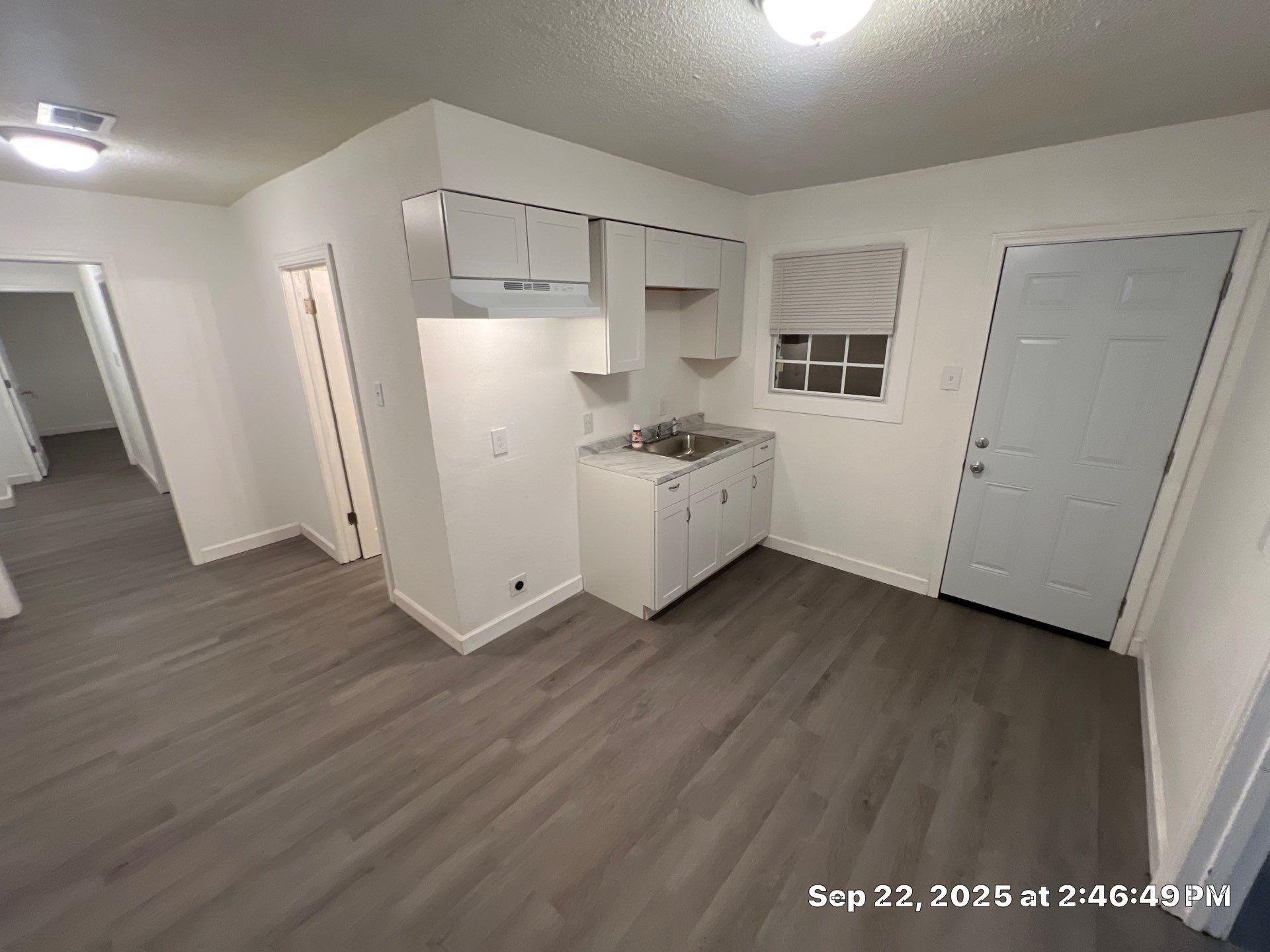 2773 Waverly Avenue Memphis, TN 38114 - Photo 13 of 20 a kitchen with cabinets and wooden floor