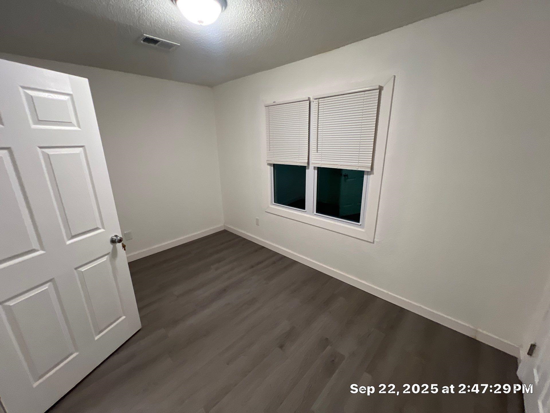 2773 Waverly Avenue Memphis, TN 38114 - Photo 18 of 20 an empty room with wooden floor and windows