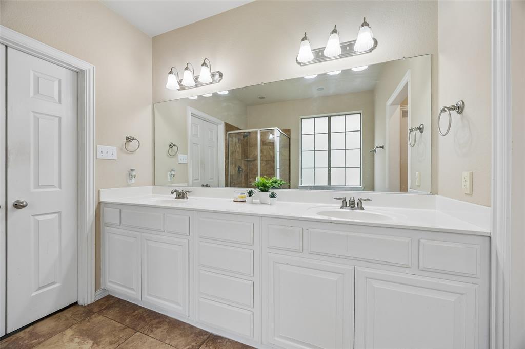 2865 Ridge View Road Frisco, TX 75034 - Photo 22 of 38 Dual vanity with white cabinetry, integrated sinks, brushed nickel fixtures, and a large wall-mounted mirror