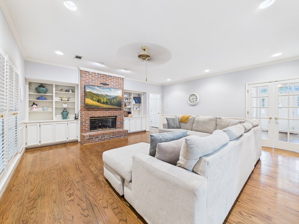 6390 Cape Cod Drive Columbus, GA 31904 - Photo 11 of 22 a living room with furniture a fireplace and a flat screen tv
