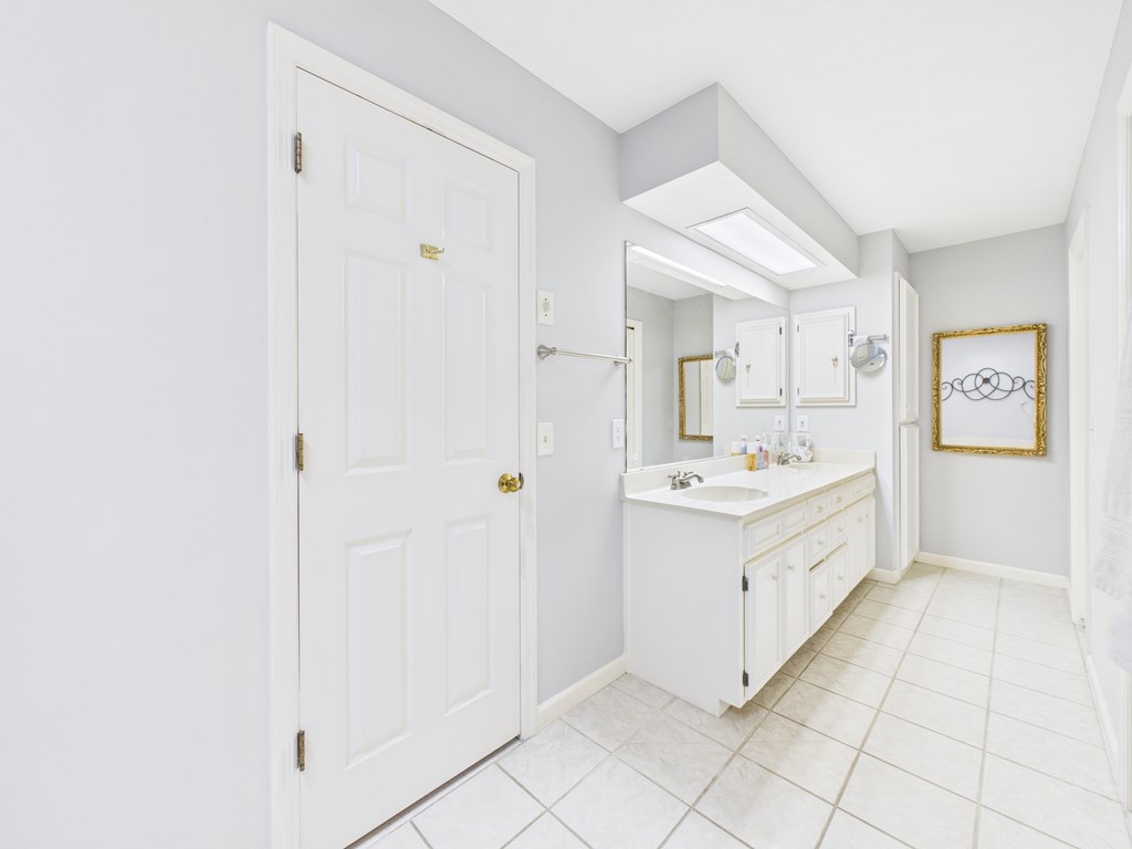 6390 Cape Cod Drive Columbus, GA 31904 - Photo 16 of 22 a large white bathroom with a sink a mirror and a bathtub