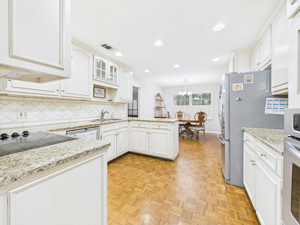 6390 Cape Cod Drive Columbus, GA 31904 - Photo 7 of 22 a large white kitchen with cabinets and a sink
