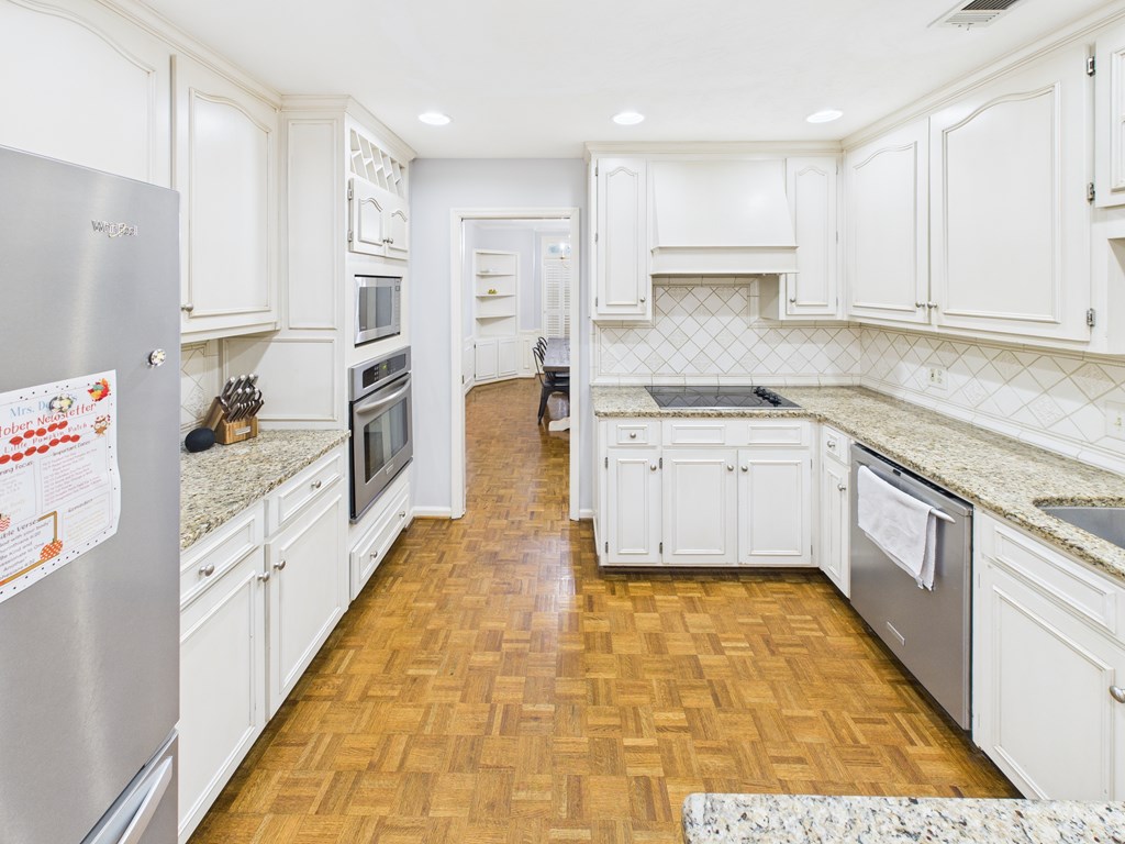 6390 Cape Cod Drive Columbus, GA 31904 - Photo 8 of 22 a large kitchen with cabinets and wooden floor