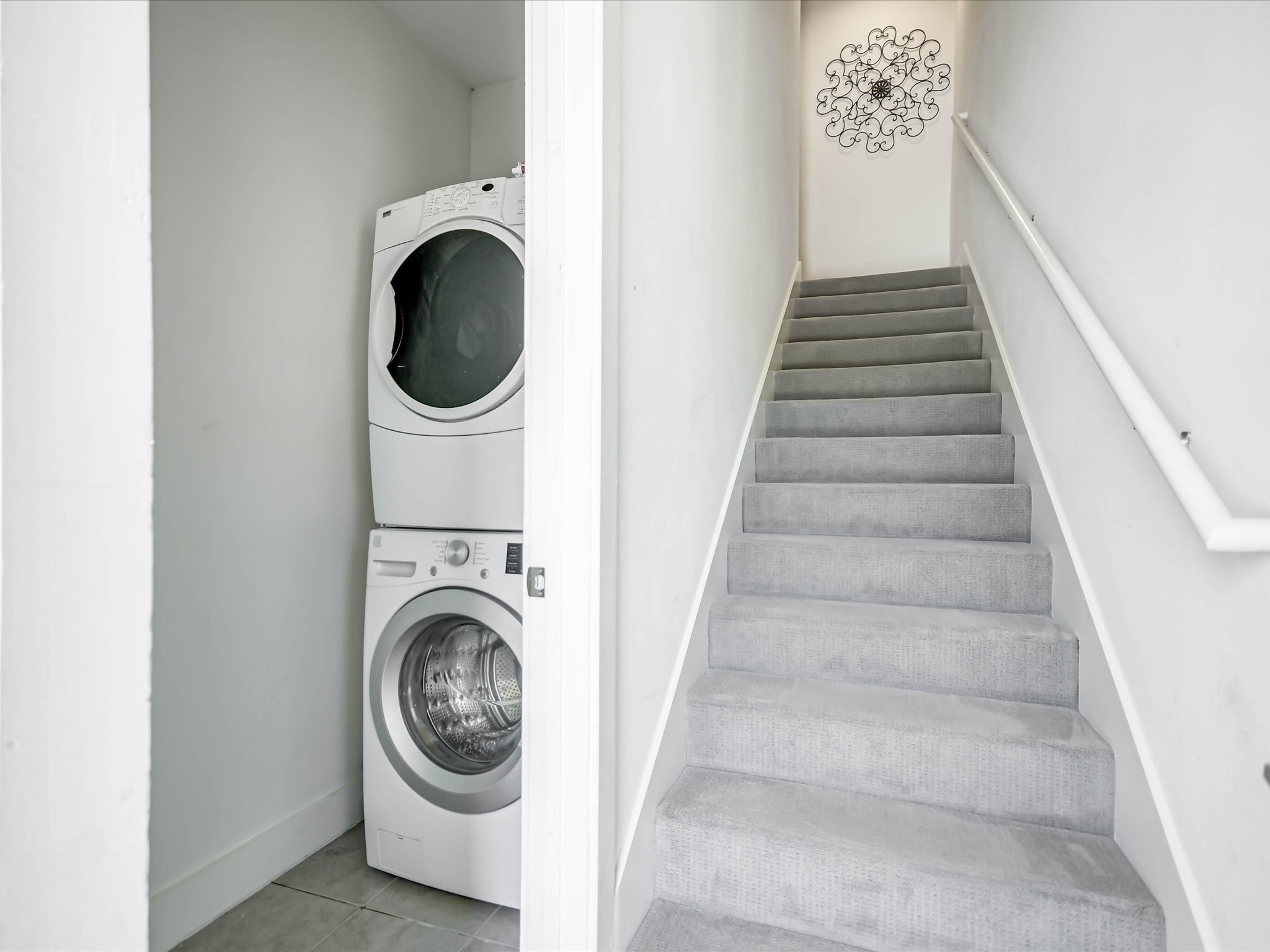 604 North Bluff Drive, Unit 101 Austin, TX 78745 - Photo 14 of 22 Laundry area featuring stacked washer / dryer and tile patterned flooring