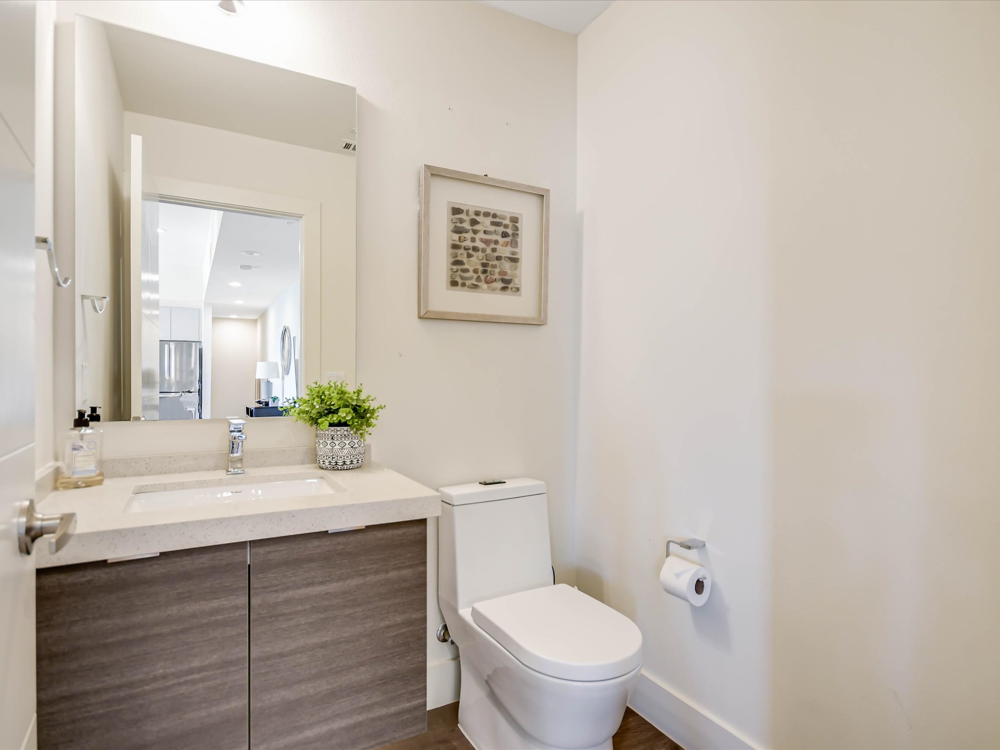 604 North Bluff Drive, Unit 101 Austin, TX 78745 - Photo 17 of 22 Half bath with toilet and vanity