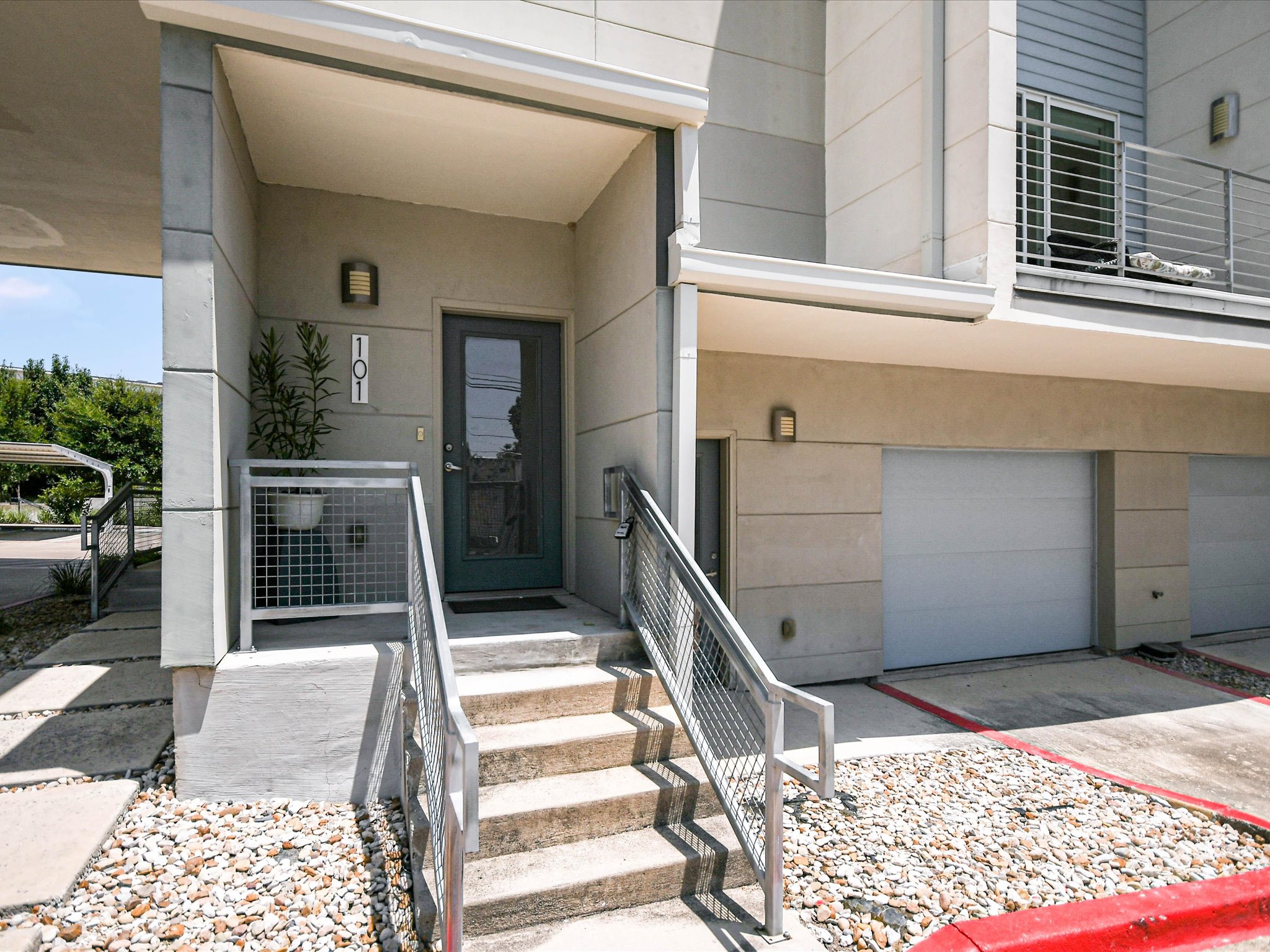 604 North Bluff Drive, Unit 101 Austin, TX 78745 - Photo 5 of 22 Property entrance with a garage and driveway