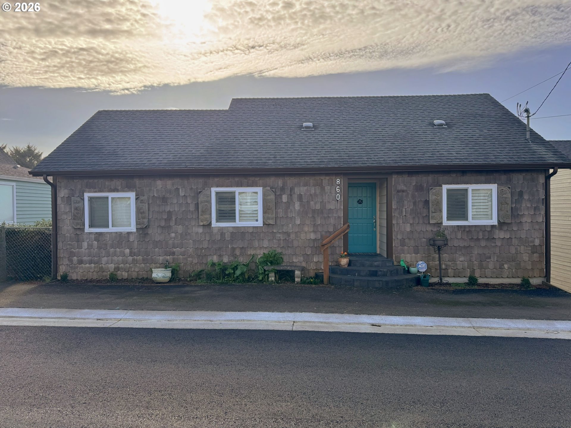 860 Southwest 10th Street Lincoln City, OR 97367 - Photo 2 of 11 a front view of a house with a yard