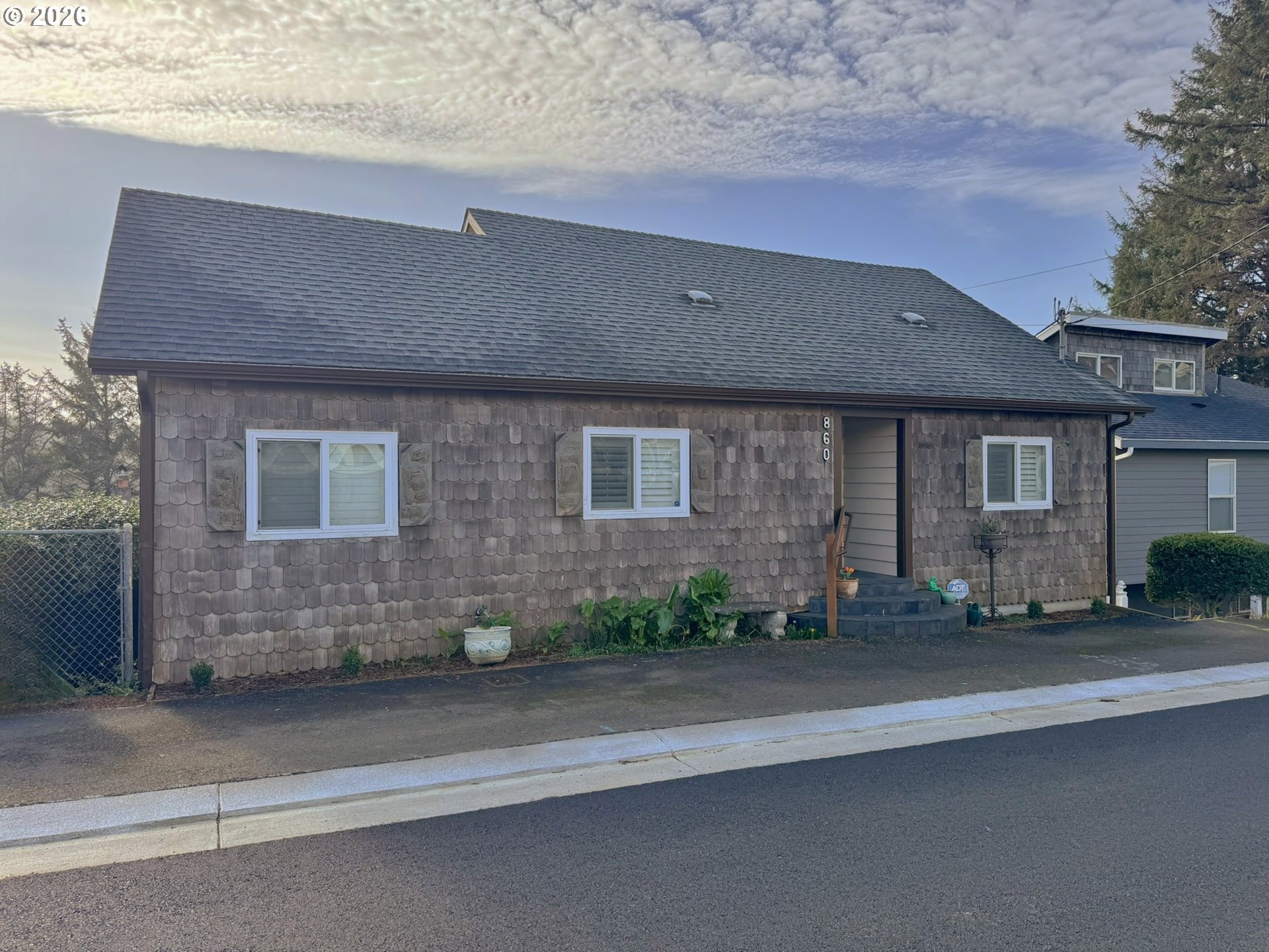 860 Southwest 10th Street Lincoln City, OR 97367 - Photo 3 of 11 a front view of a house with a yard